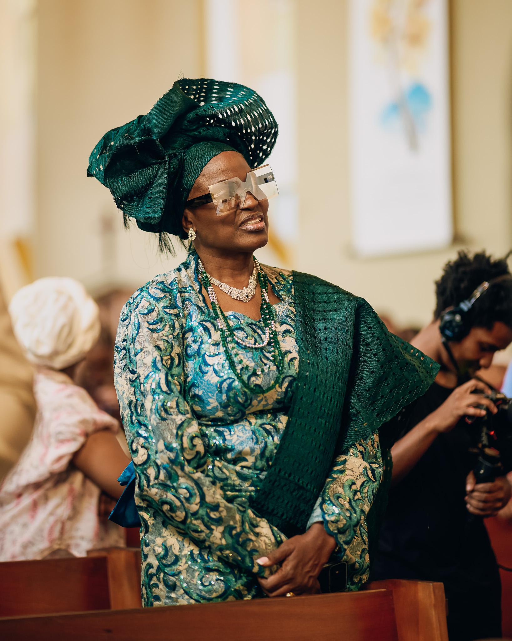 Guest in green traditional attire during the church service.